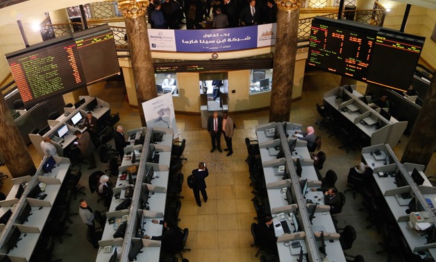 FILE - Employees in the EGX following performance of the trading session 